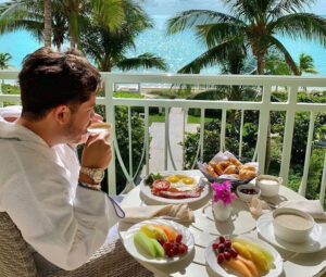 Man taking sumptuous brunch with a view. 